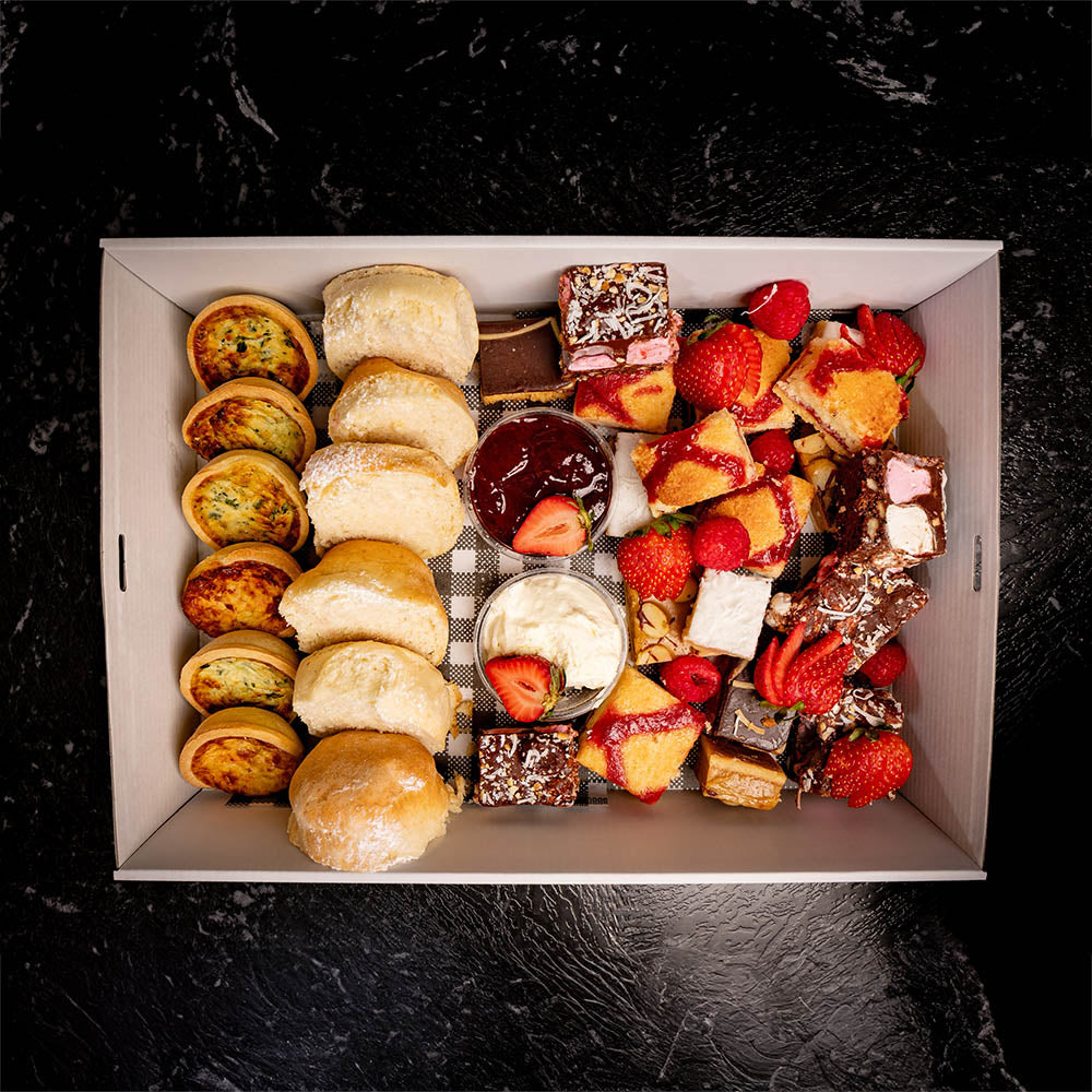 A box filled with assorted sweet and savoury slices and pastries.